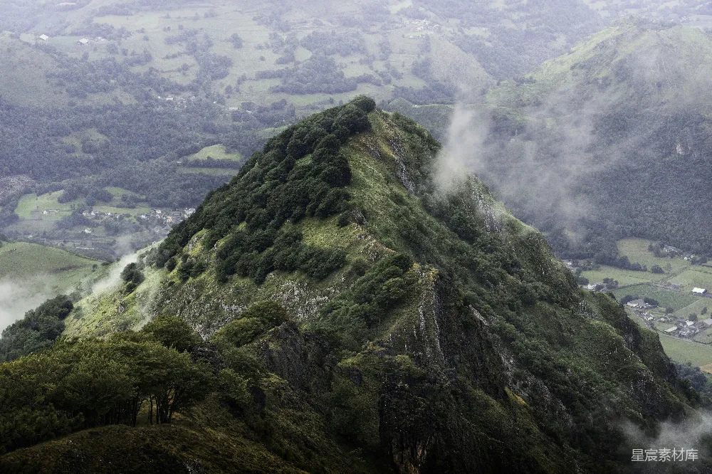 高清摄影  一座山，山上有树木，山下是一片山谷。