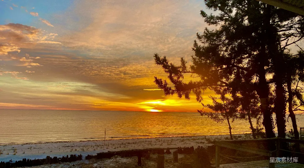 高清摄影  夕阳正在海洋上落下，海滩上一片宁静。