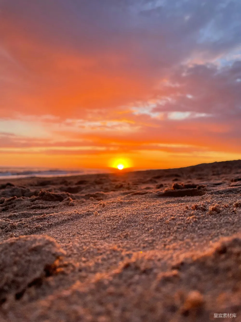 高清摄影  夕阳照耀着沙滩，地上铺满了沙子。