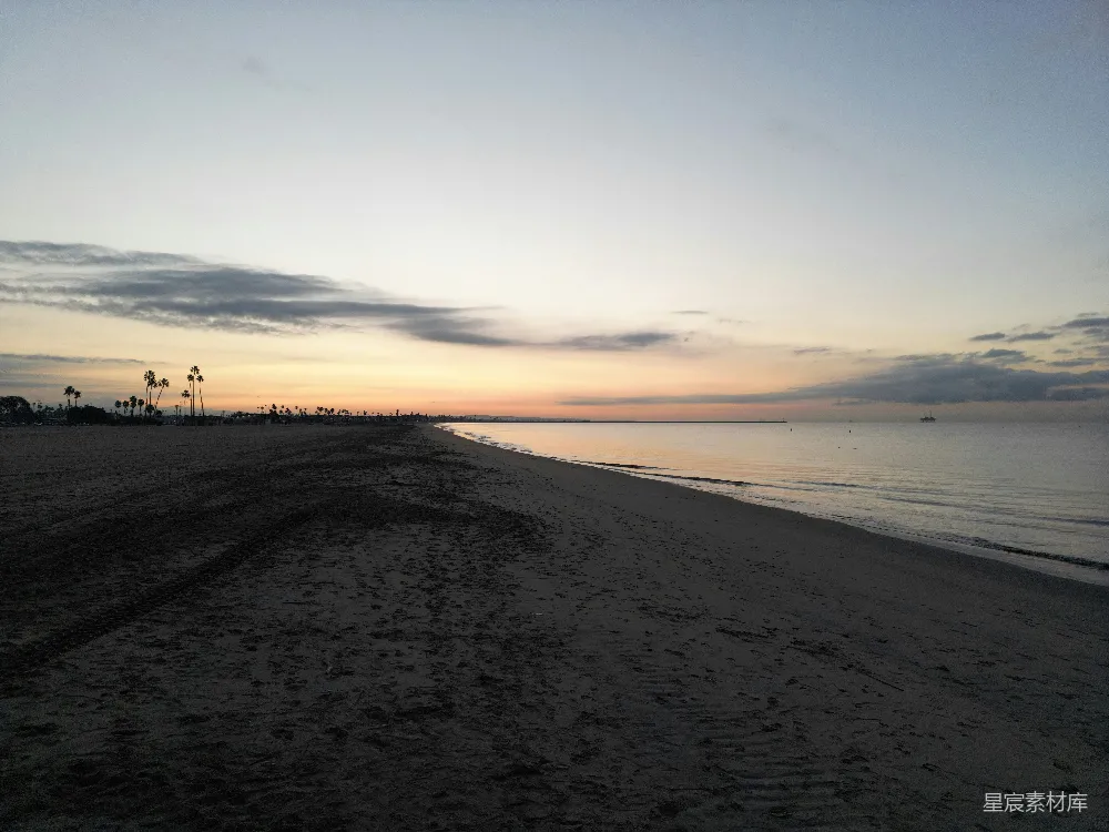 高清摄影  沙滩上，夕阳在背景中照耀着。