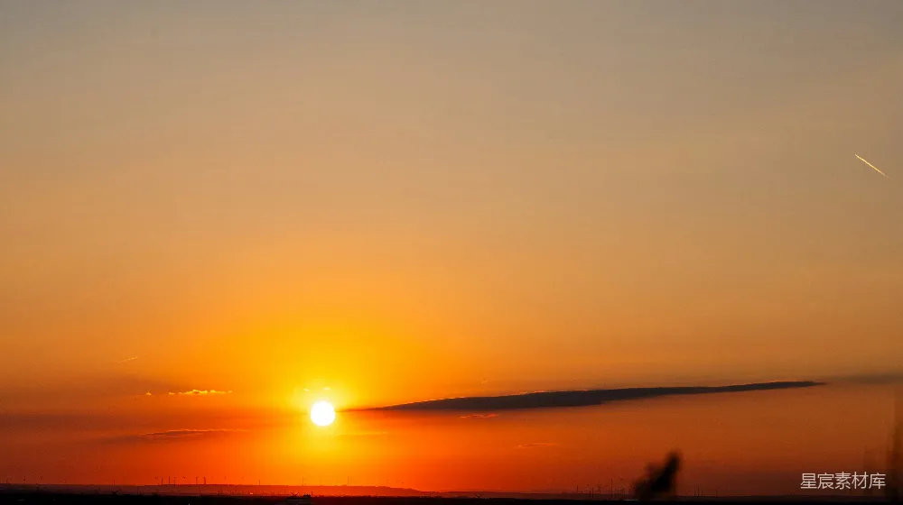 高清摄影  夕阳在地平线上落下，天空中有一片乌云。