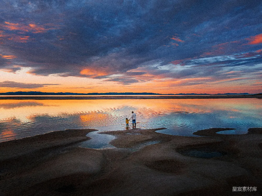 高清摄影 旅行 人物 两个人站在水中，夕阳西下。