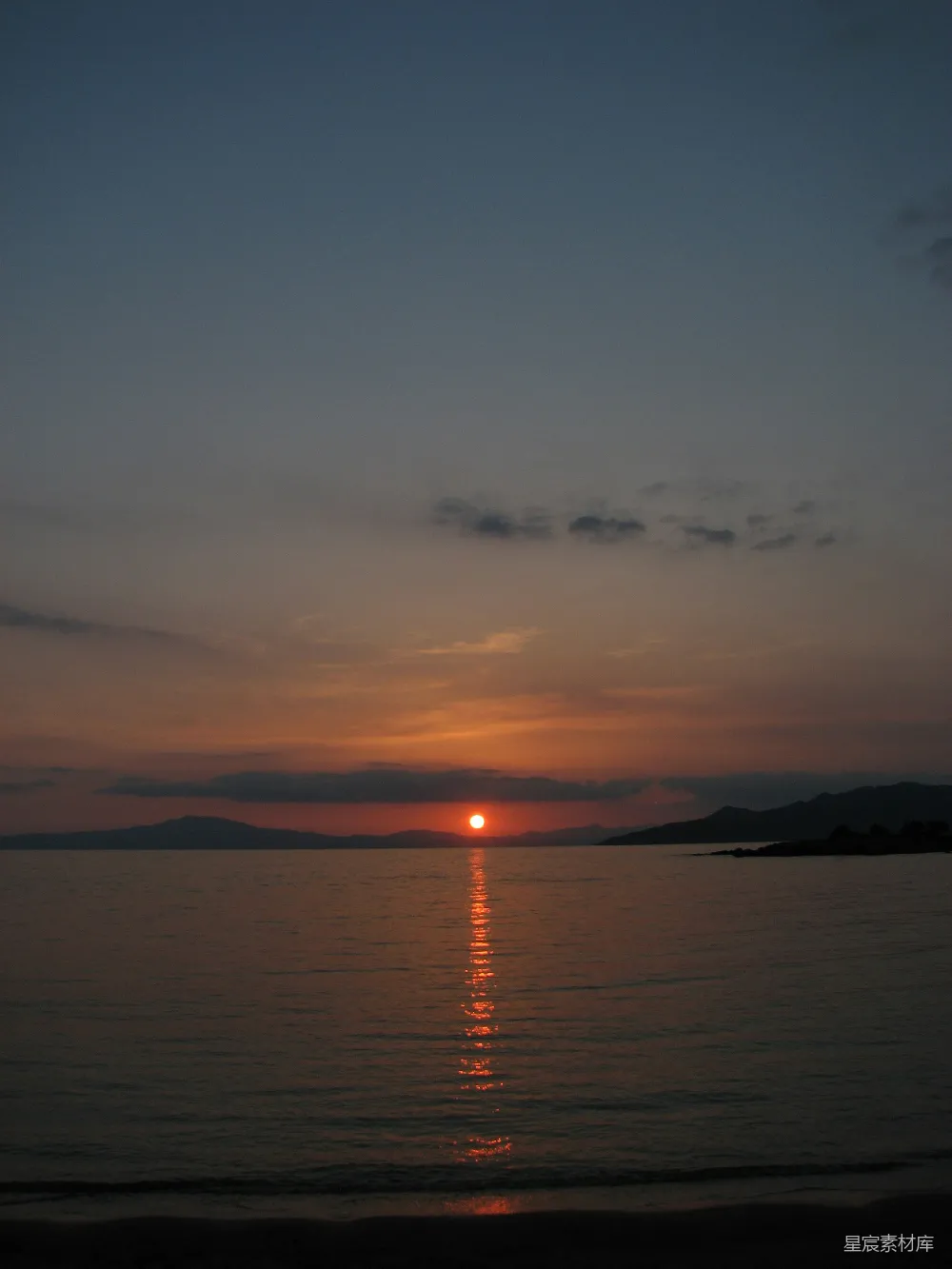 高清摄影  夕阳正照在海滩的水面上。