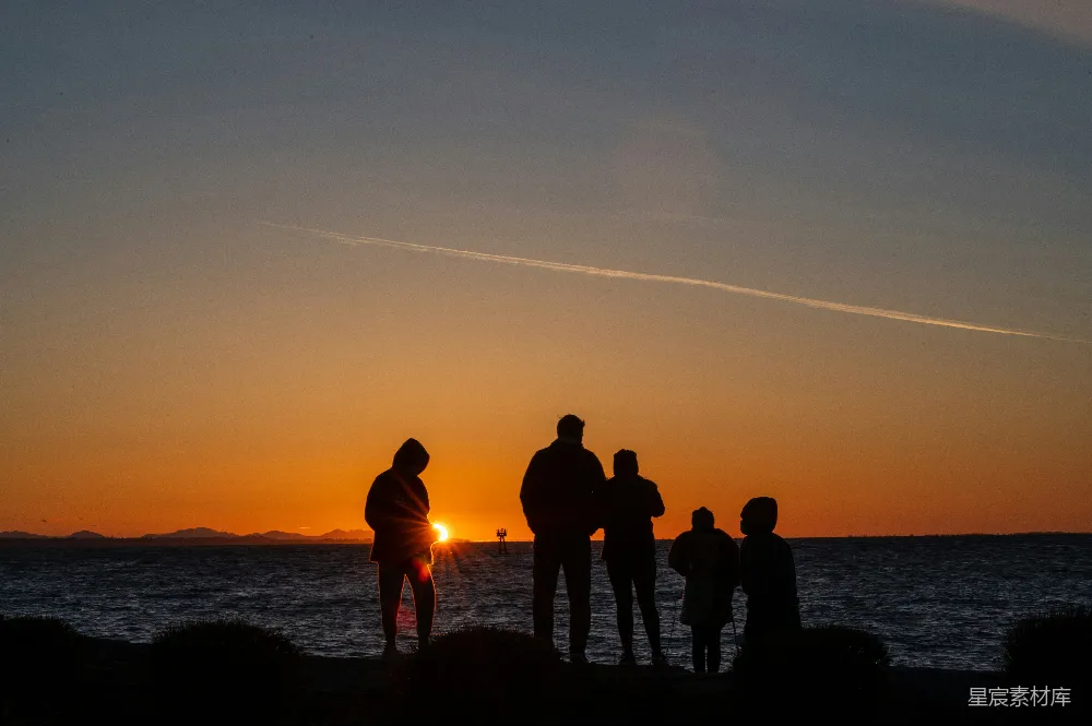 高清摄影 自然 夕阳下，人们站在海边的剪影