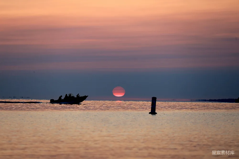 高清摄影  一艘船在夕阳下在水面上行驶
