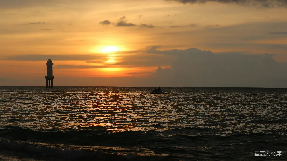 高清摄影  夕阳正挂在海平面上，一艘船静静地漂浮在水面上。