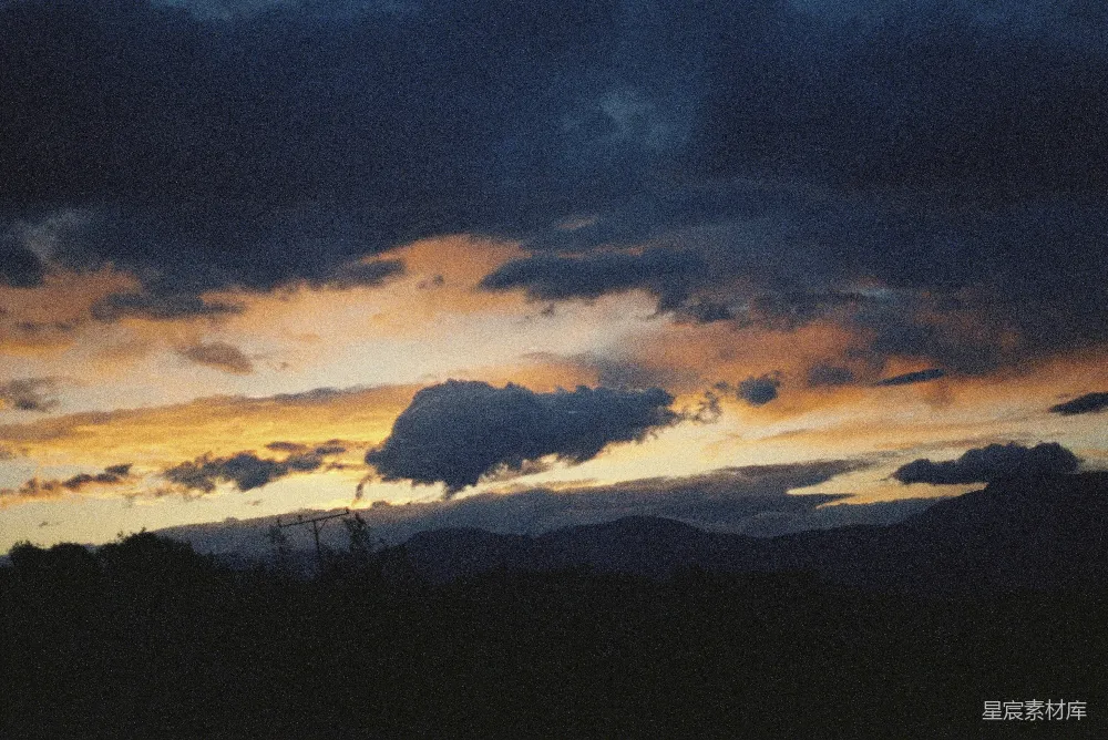 高清摄影 电影 夕阳西下，云彩与山峦在背景中。