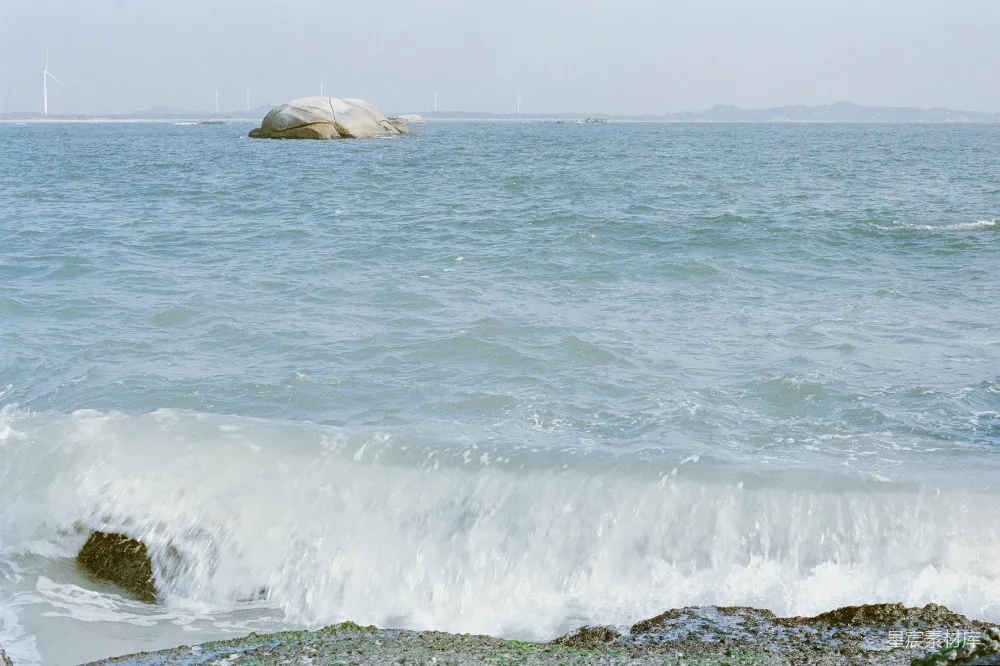 高清摄影 电影 海浪拍打着岩石海岸，海中有一块大岩石。