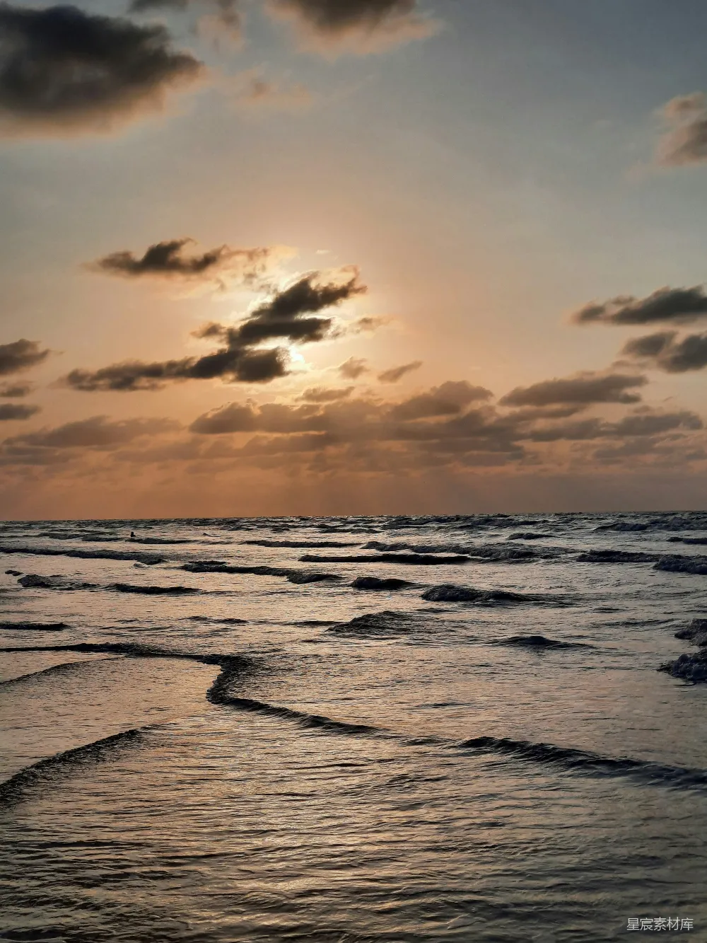 高清摄影 旅行 自然 夕阳映照在海洋上，波浪轻轻拍打着岸边。