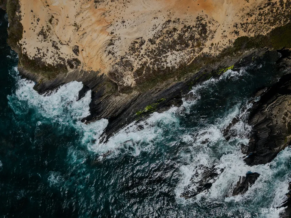 高清摄影  海浪拍打着岩石海岸线，从上方俯瞰。