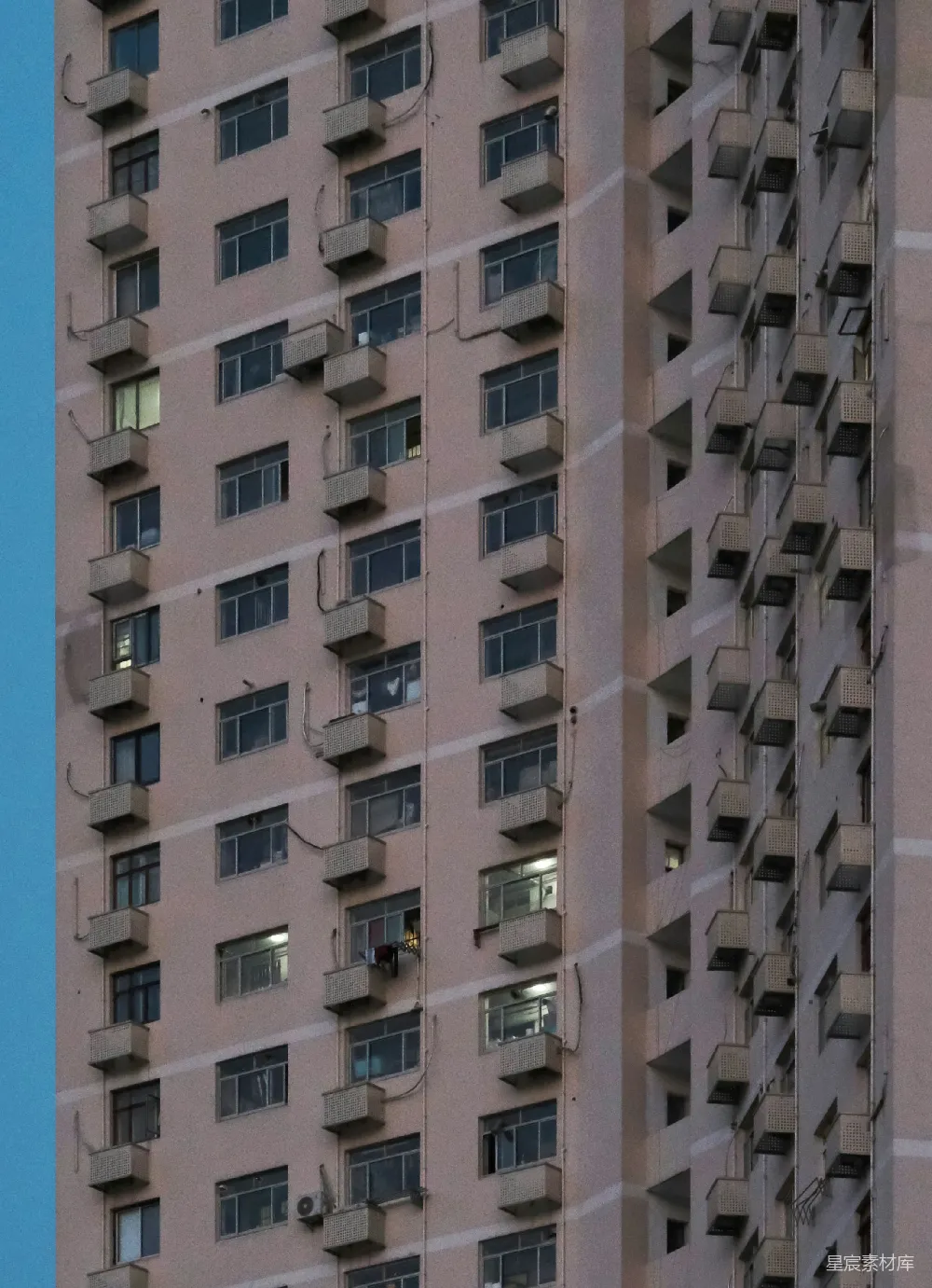 高清摄影  一座高大的住宅楼，有许多窗户和空调。