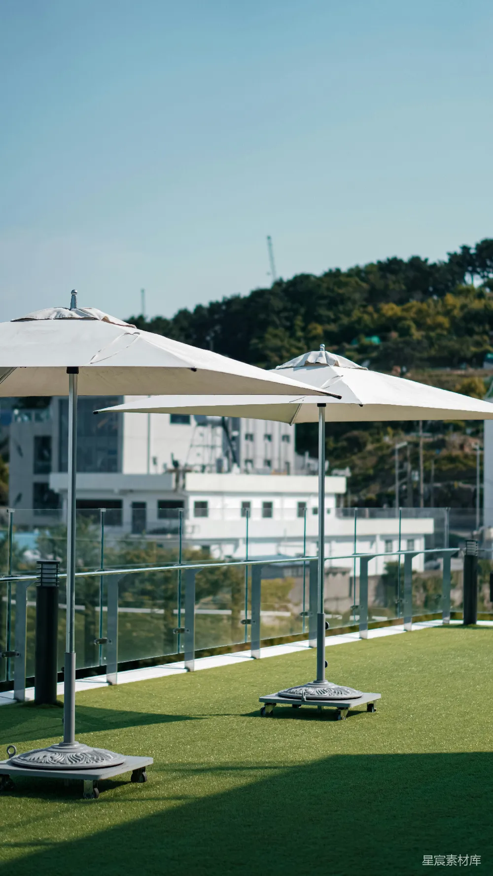 高清摄影  一排雨伞坐落在郁郁葱葱的绿色田野上