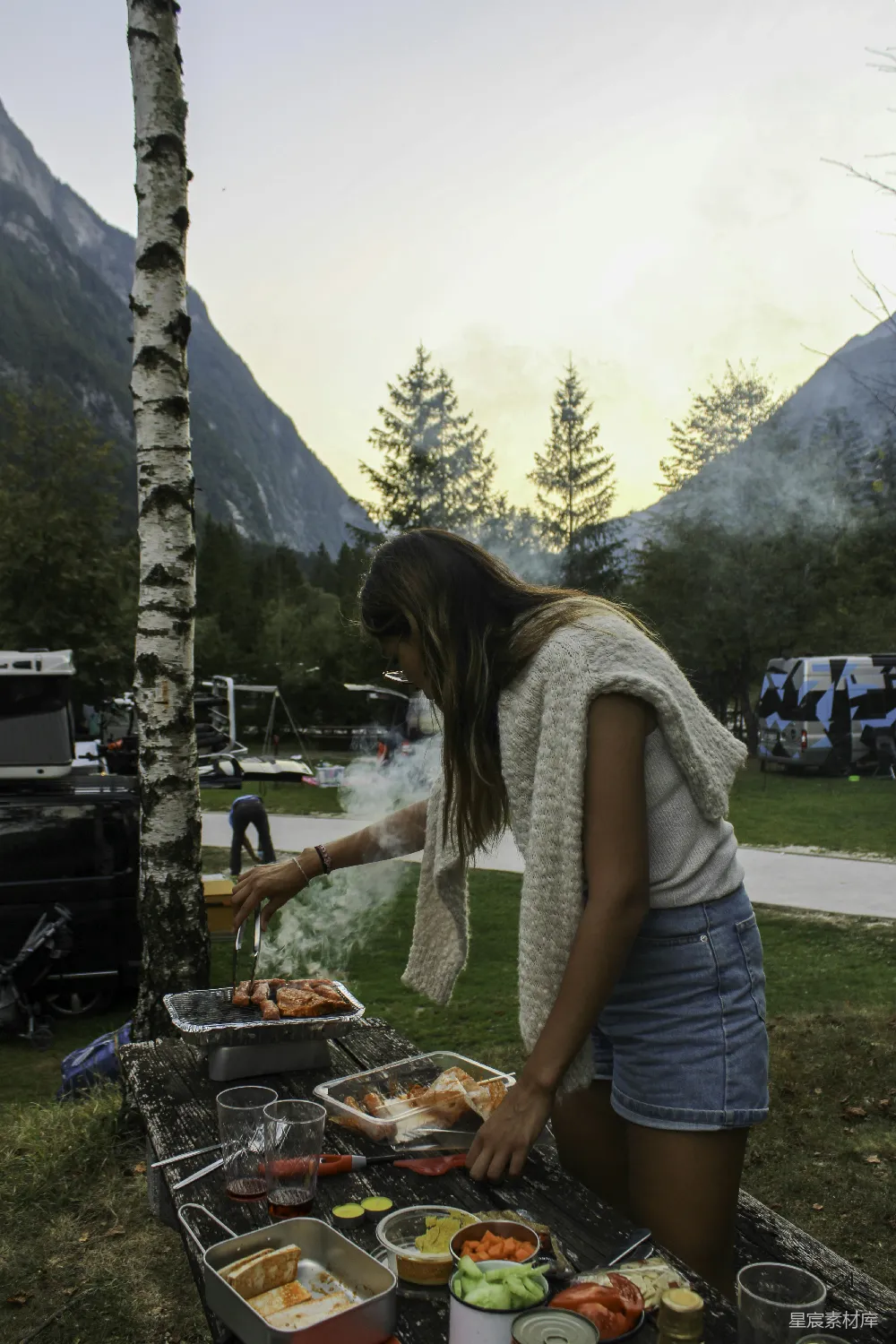 高清摄影  一个女人站在摆满食物的桌子旁