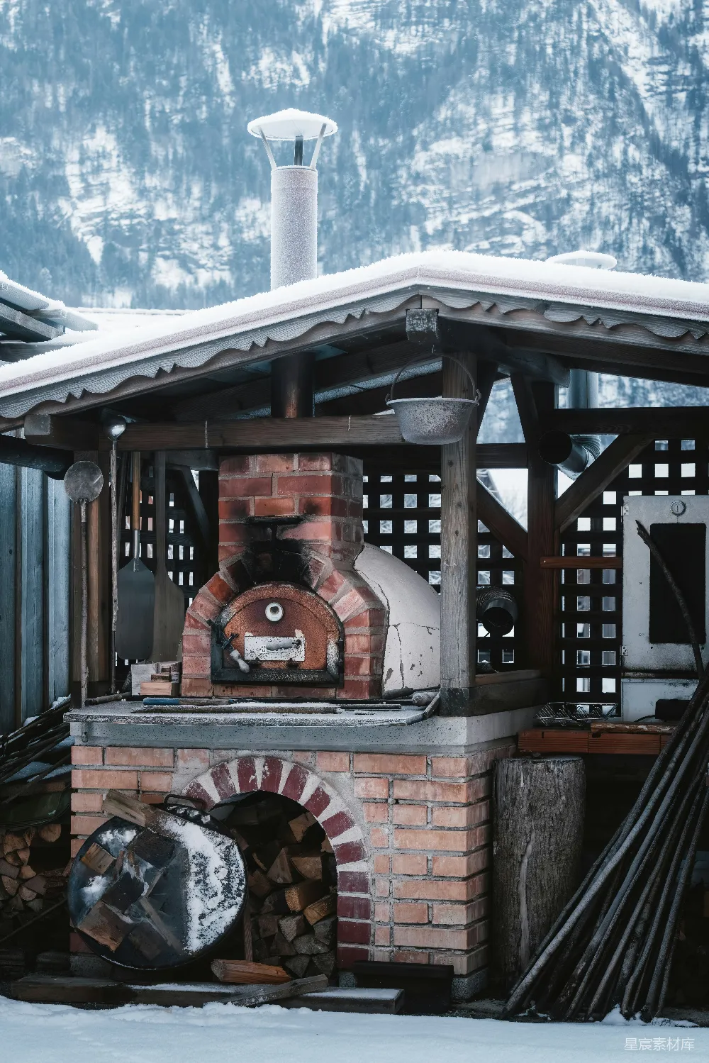 高清摄影  一座砖炉子坐落在积雪覆盖的院子里。