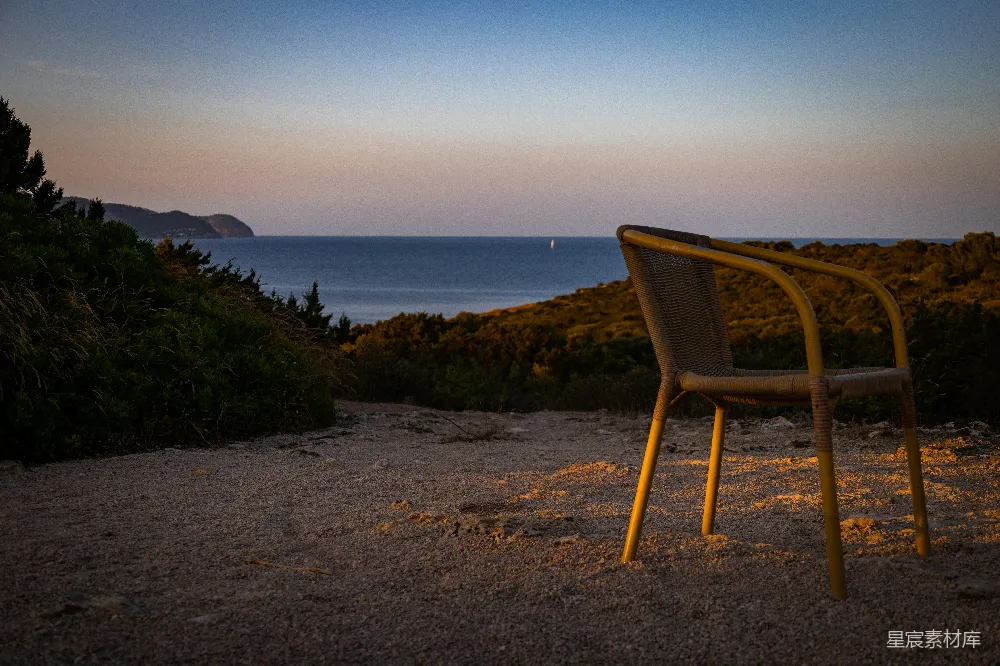 高清摄影  夕阳下，一把孤椅俯瞰着大海。