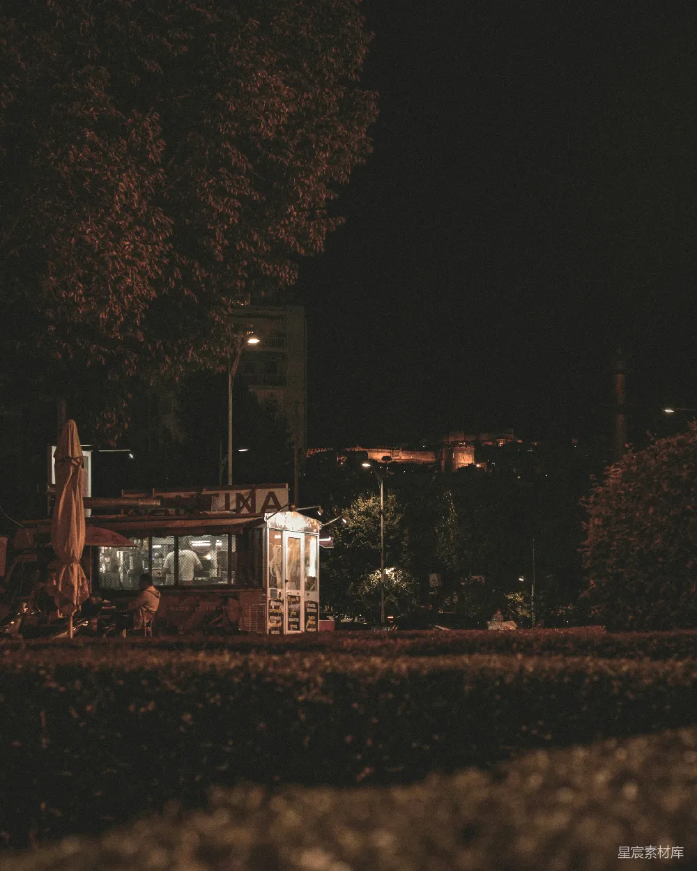 高清摄影  夜晚时分，一家餐厅的景色，背景中可以看到树木。