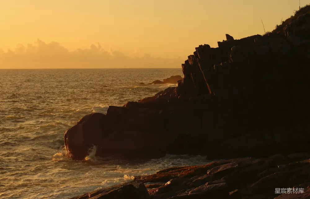 高清摄影  夕阳正映照着海面和岩石。