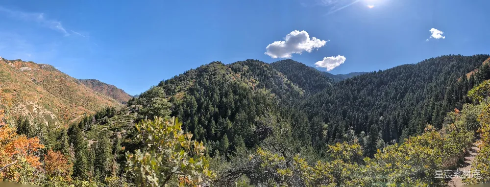 高清摄影  一幅山峦的美景图，前景中树木葱翠。