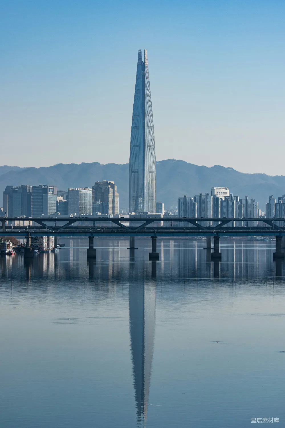 高清摄影  一片广阔的水域，背景中有座城市。