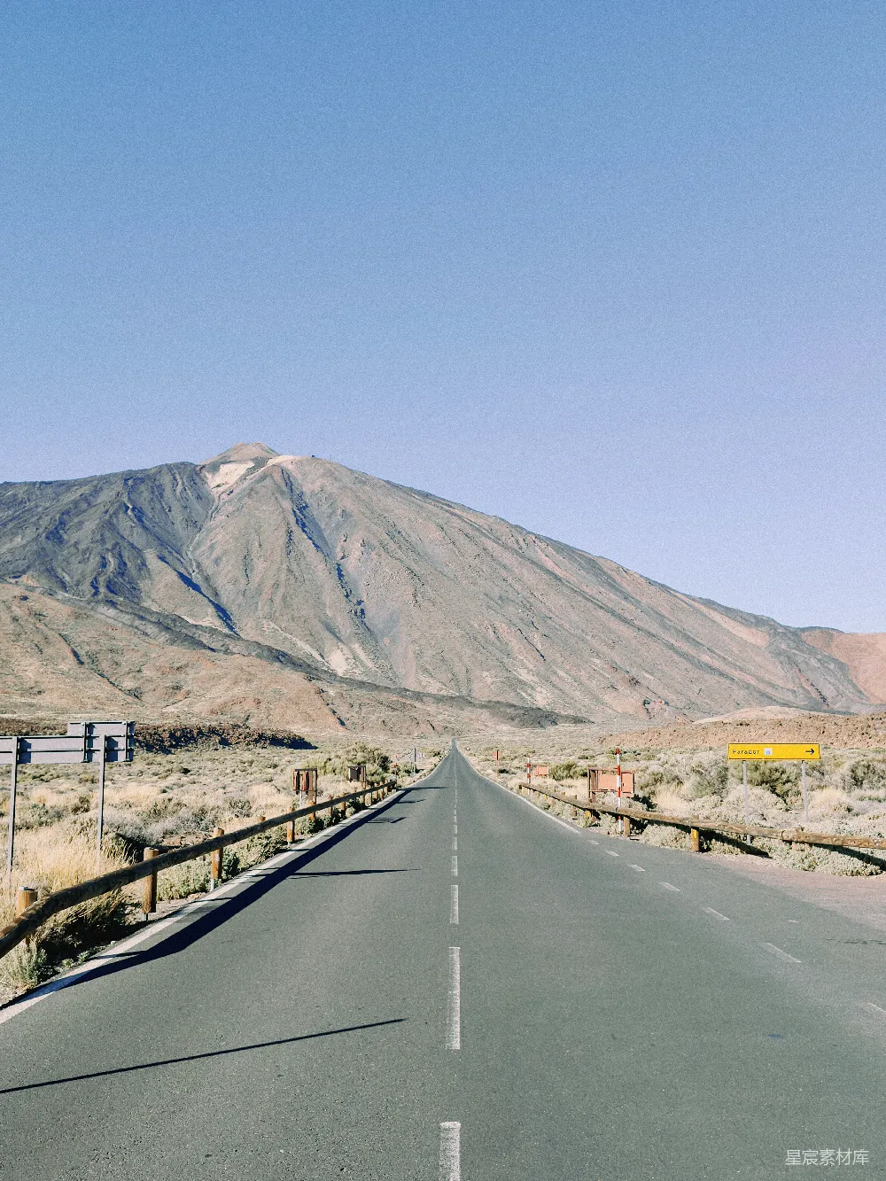 高清摄影  一条空旷的道路，背景中有一座山。