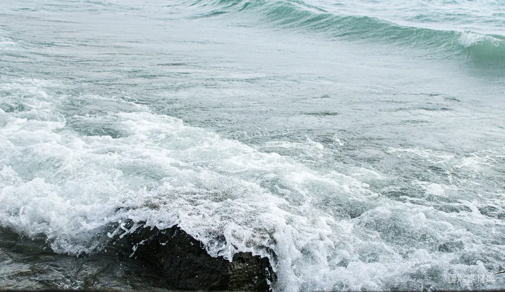 高清摄影  一个人骑在冲浪板上，在波浪上冲浪