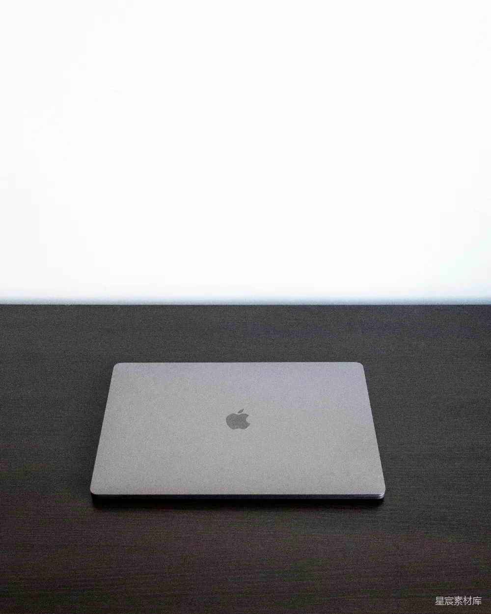 高清摄影  银色的MacBook放在棕色的木桌上。