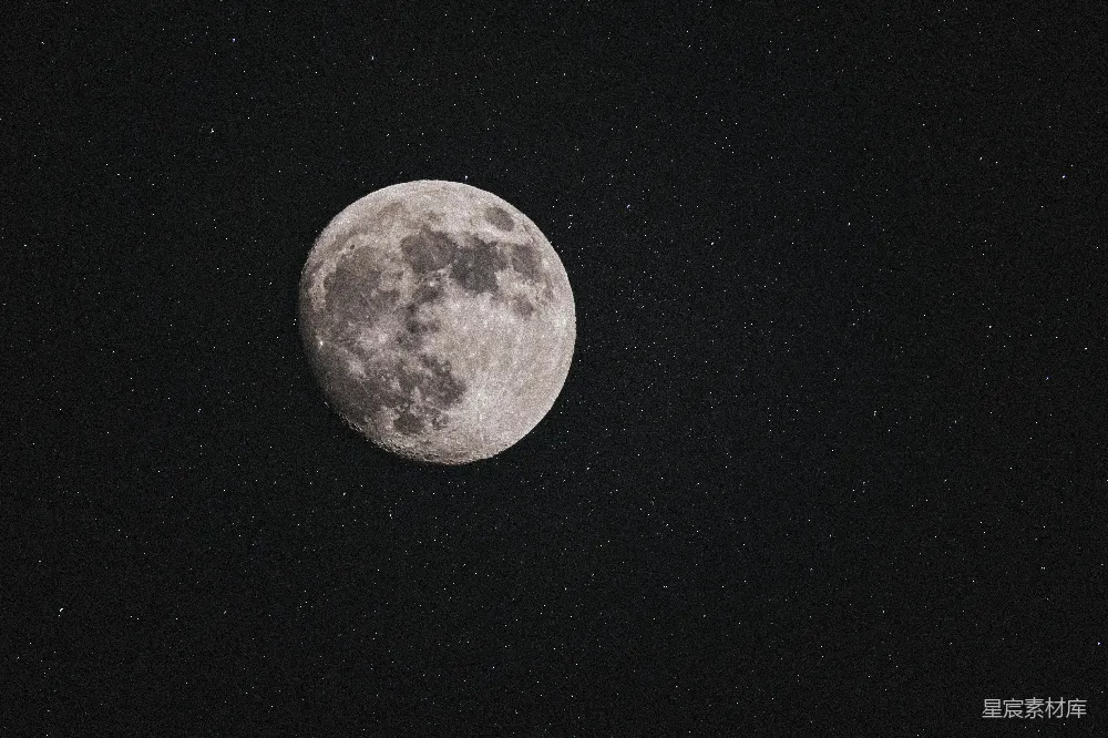 这张图片展示了一个宁静的夜空场景，中心是一轮明亮的月亮，周围点缀着星星。月亮的表面细节清晰可见，给人一种神秘而宁静的感觉。适合用于自然风光、宇宙探索或宁静心灵的背景。