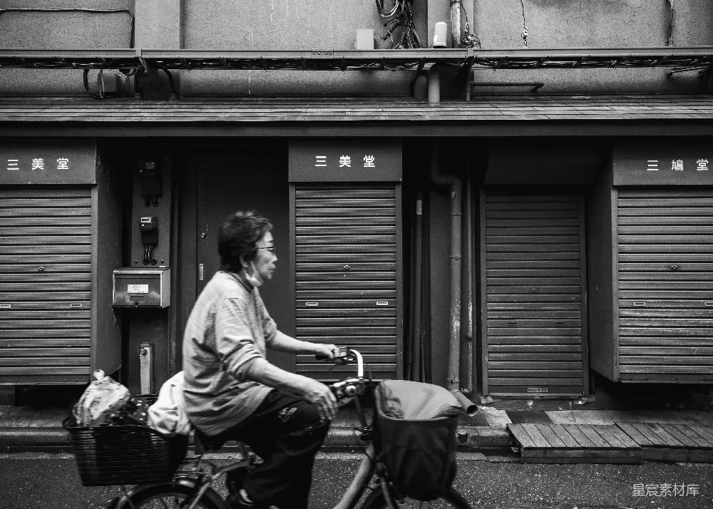 高清摄影 黑白色调 城市生活 日常场景 慢生活 日本风情 街头慢行的老年骑车人