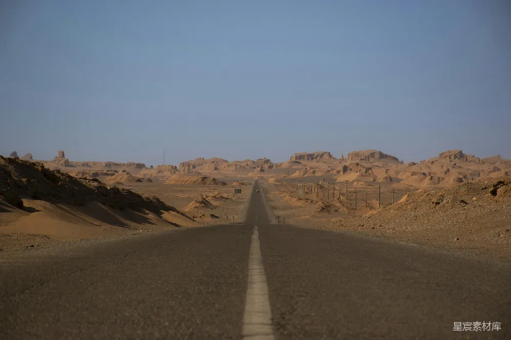 一条笔直的公路延伸至远方，两旁是广袤无垠的沙漠，天空湛蓝，地平线一望无际。画面中没有车辆和行人，只有那条孤独的公路，仿佛在诉说着旅行的寂寞与远方的未知。