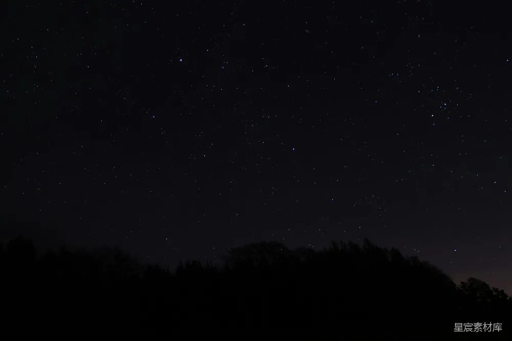 这张图片展示了一个宁静的夜晚，天空中布满了星星，下方是森林的剪影。黑暗的夜空与明亮的星星形成了鲜明的对比，营造出一种宁静而神秘的氛围，适合用于自然风光、宁静时光或星空摄影的背景图片。
