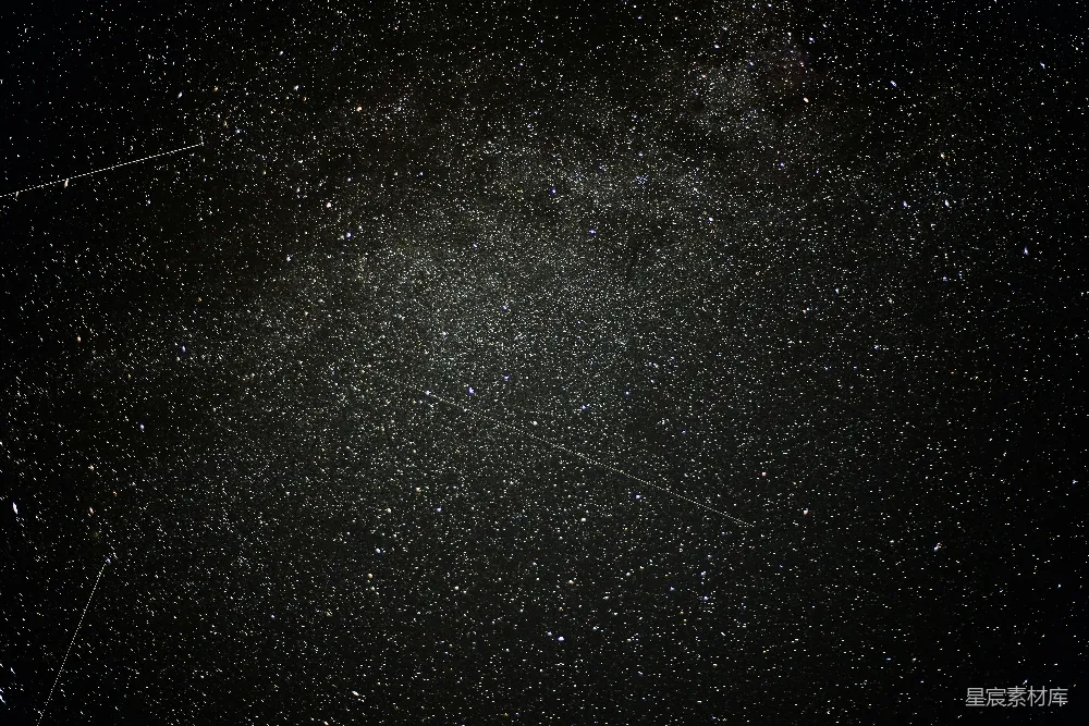 这张图片展示了夜空中繁星点点的景象，其中包含了一条明亮的流星轨迹，仿佛在夜空中划出一道美丽的弧线。背景是深邃的夜空，点缀着无数的小星点，营造出一种宁静而神秘的氛围。适合用于天文摄影、宁静场景或宇宙主题的背景。