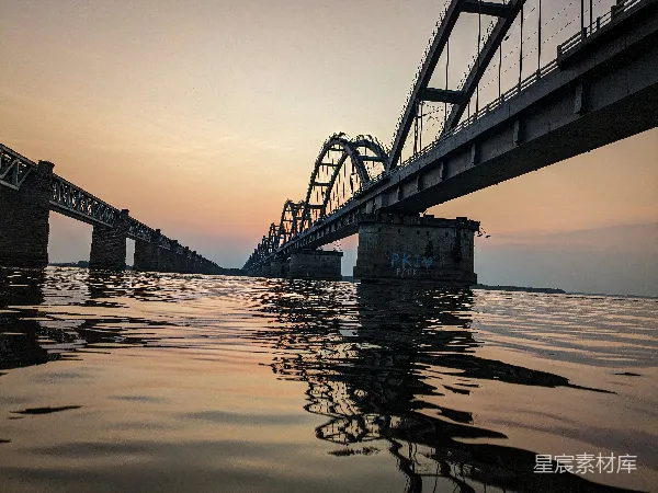 高清摄影 夕阳下的水面上的一座桥