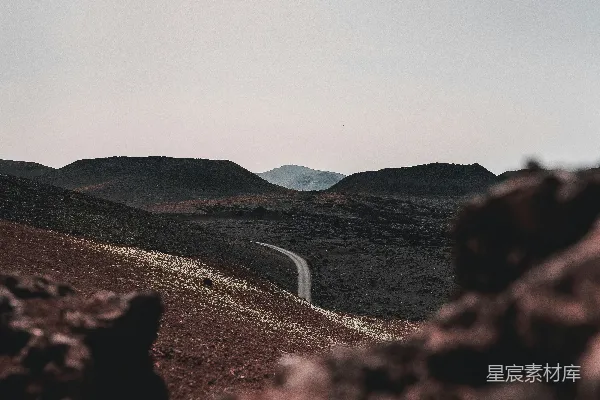 高清摄影 蜿蜒穿过一片荒芜的火山景观的道路