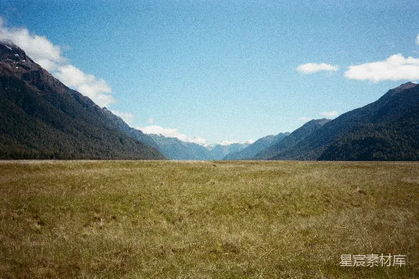 高清摄影 绵延的草地夹在两座森林山脉之间