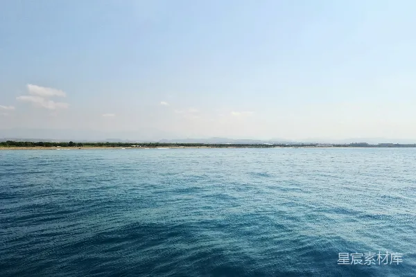 高清摄影 平静的远处未开发海岸边的浅蓝色海水