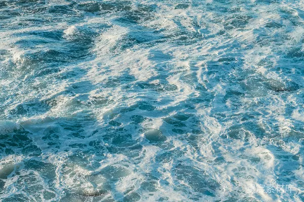 高清摄影 海边一名男子站在冲浪板上享受海浪的起伏。