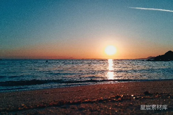 高清摄影 夕阳下的平静海洋与沙滩。