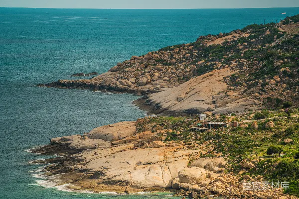 高清摄影 岩石嶙峋的海滩上有建筑物。