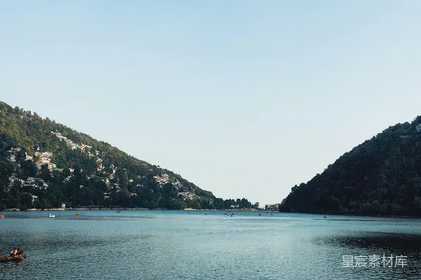 高清摄影 水面有一群船只，山峦在背后。