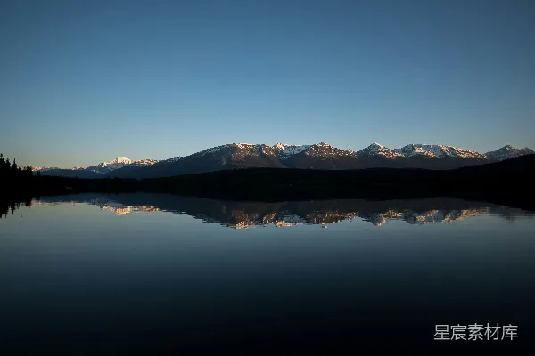 高清摄影 傍晚雪山倒映在平静的湖水中。