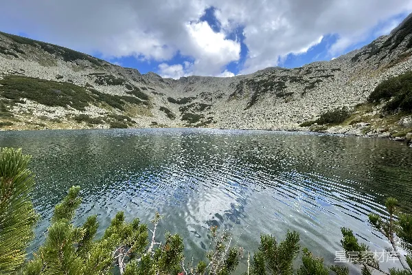 高清摄影 一座被山峦环抱的湖泊，在阴云密布的天空下