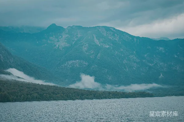 高清摄影 绿色和白色的山靠近湖体的白天景色