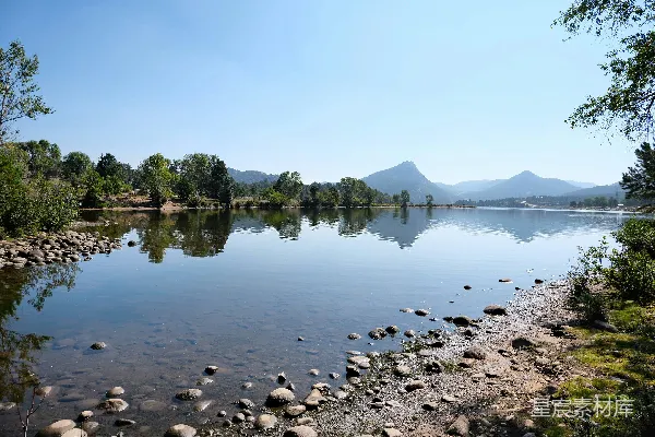 高清摄影 平静的湖面映照着美丽的阳光下的山景。