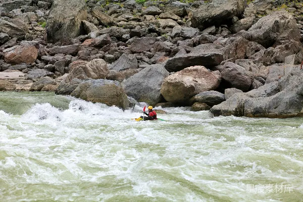 高清摄影 河岸边环绕着岩石的人坐在 kayak 中。