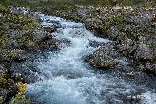 高清摄影 一条河流流经一片翠绿的山坡上
