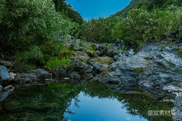 高清摄影 天空和山峦倒映在清澈的水面上。