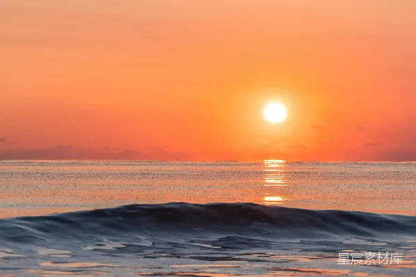 高清摄影 夕阳西下，海面上有一道波纹在 foreground。