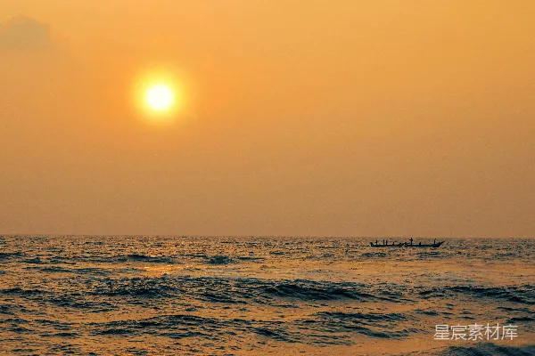高清摄影 夕阳西下，海面上停着一条船。