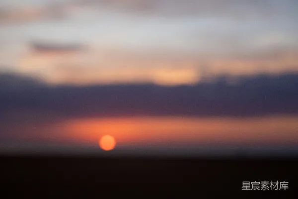 高清摄影 黄昏时分一抹模糊的落日映衬在暗淡的地平线上