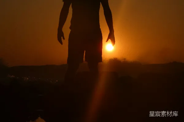 高清摄影 夕阳下站立在岩石上的男子轮廓
